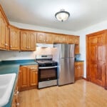 Kitchen Showing Cabinetry And Basement Door