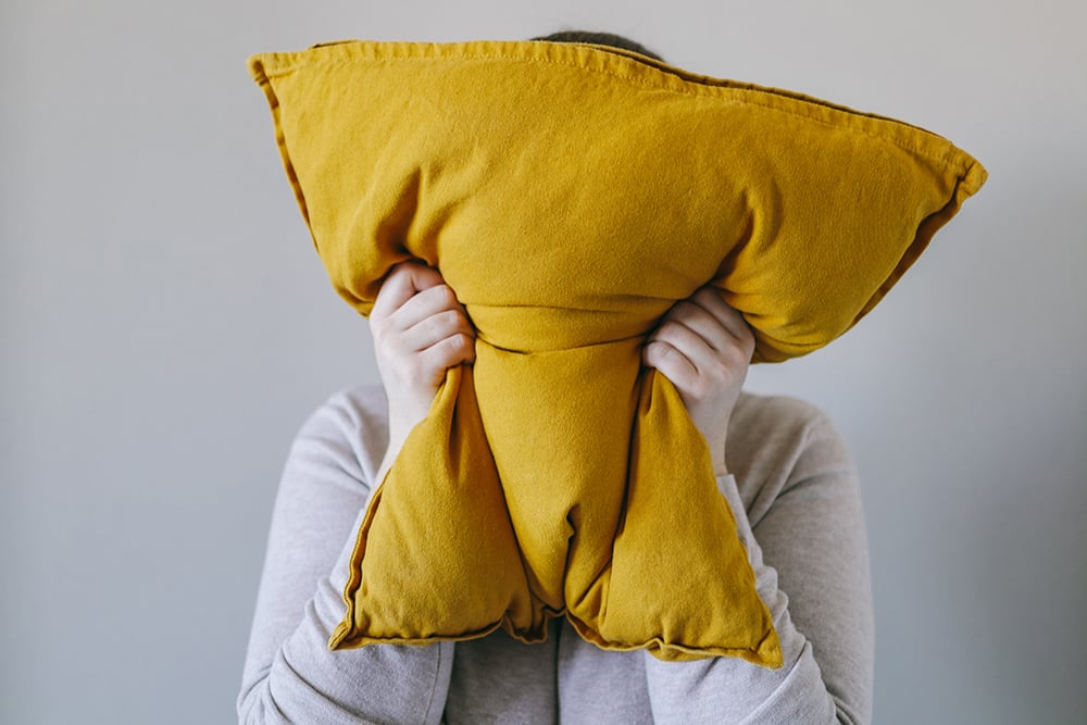 Woman,squeezes,a,pillow,with,her,hands,,the,concept,of